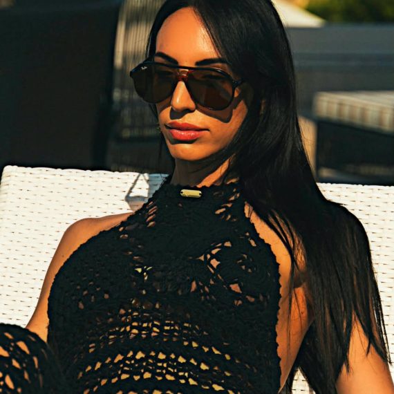 Handcrafted Noir Siren crochet maxi dress featuring intricate crochet detailing, an elegant flowing silhouette, and sophisticated black tones inspired by coastal evening glamour.